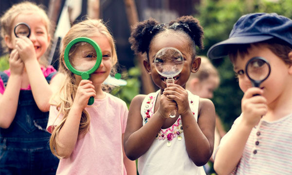 Kids playing with magnifying glasses